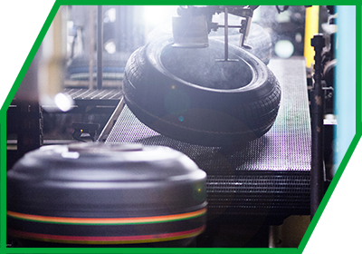 Reifenrohlinge auf Förderband im nebeligen Werk